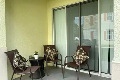 a group of chairs and a table on a balcony at LUXURY and VINTAGE space to enjoy your vacation!! in Kissimmee