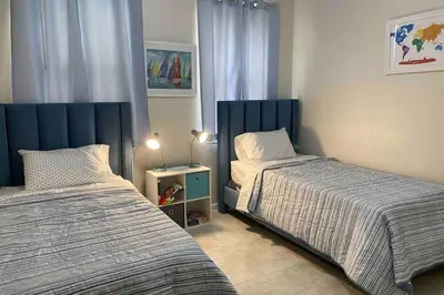 a bedroom with two beds and a table with a lamp at LUXURY and VINTAGE space to enjoy your vacation!! in Kissimmee