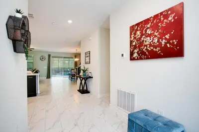 a living room with a painting on the wall at 9 Bed Storey Lake Resort Game Room Pool home in Kissimmee