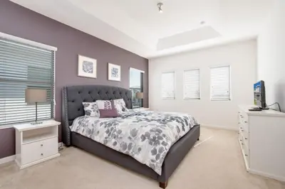 a bedroom with a large bed and windows at 5 Bed 5 Bath in 5 Star Resort Near Disney! home in Kissimmee
