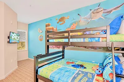 a bedroom with a bunk bed with a fish mural on the wall at Stunning 3BR Near Disney - Pool in Orlando