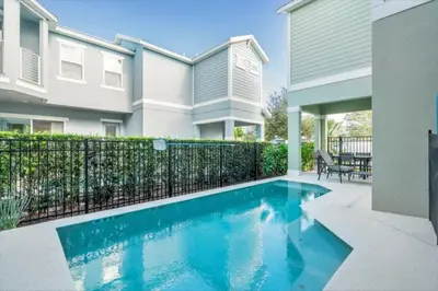 a swimming pool in front of a house at Beautiful Home Near Disney with Private Pool! villa in Orlando