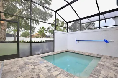 an indoor swimming pool with a glass ceiling at Amazing 3 bedroomloft townhouse in Hidden Forest, with private pool! in Orlando