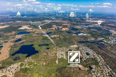 an aerial view of the estate with the city in the background at Amazing 3 bedroomloft townhouse in Hidden Forest, with private pool! in Orlando