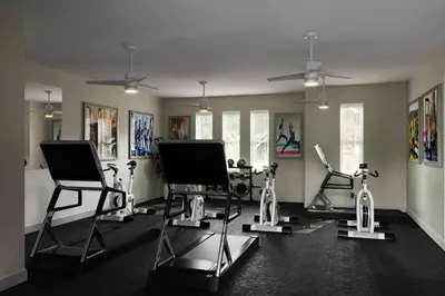 a gym with several exercise bikes in a room at Amazing 3 bedroomloft townhouse in Hidden Forest, with private pool! in Orlando