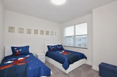 a bedroom with two beds and a window at Amazing 3 bedroomloft townhouse in Hidden Forest, with private pool! in Orlando