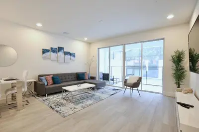 a living room with a couch and a table at High luxury 3 bedroomloft townhouse in Hidden Forest, with private pool! in Orlando