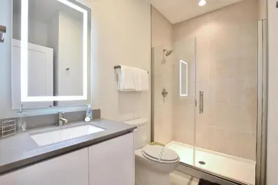 a bathroom with a toilet and a sink and a shower at High luxury 3 bedroomloft townhouse in Hidden Forest, with private pool! in Orlando