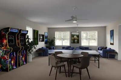 a room with a table and chairs and consoles at High luxury 3 bedroomloft townhouse in Hidden Forest, with private pool! in Orlando
