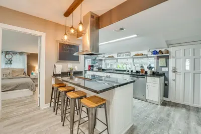 a kitchen with a counter and bar with stools at Family Home with Private Pool 24 Mi to Disney! in Saint Cloud