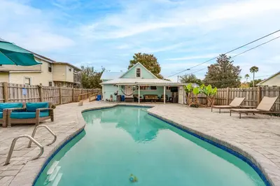 a swimming pool in a yard with chairs and a house at Family Home with Private Pool 24 Mi to Disney! in Saint Cloud