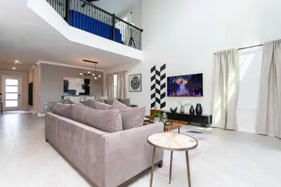 a living room with a couch and a table at Gorgeous 5BDR Family with Pool at Storey Lake 2767 O in Kissimmee