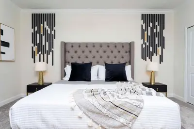 a bedroom with a large white bed with two lamps at Gorgeous 5BDR Family with Pool at Storey Lake 2767 O in Kissimmee