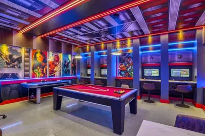 a room with a pool table and arcade games at Amazing Game Room Your Kids Will Love! villa in Kissimmee