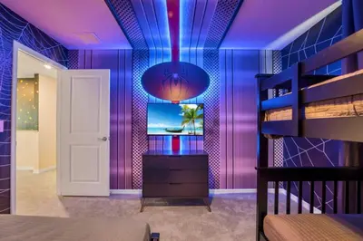 a room with purple walls and a bedroom with a bunk bed at Amazing Game Room Your Kids Will Love! villa in Kissimmee
