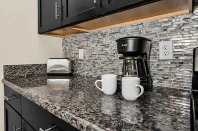 two coffee cups sitting on a counter in a kitchen at Spacious and Luxurious Home With Splash Pool, Close to Disney #4ST804 in Kissimmee