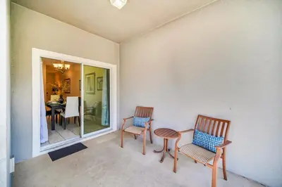 a room with two chairs and a table and a dining room at Spacious and Luxurious Home With Splash Pool, Close to Disney #4ST804 in Kissimmee