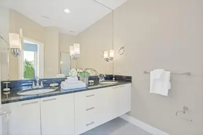a white bathroom with two sinks and a shower at 3 bed Town Home With Splash Pool! townhouse in Orlando