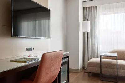 a hotel room with a desk and a chair at Marriott Orlando Downtown in Orlando