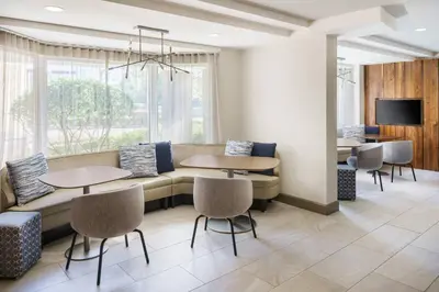 a waiting room with tables and a couch at Courtyard by Marriott Orlando Downtown in Orlando