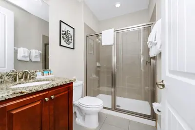 a bathroom with a shower and a toilet and a sink at Spectacular Home Near Disney With Private Pool, Movie Theater And Pool Table With Waterpark & Resort Access - 332Sf in Kissimmee