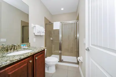 a bathroom with a shower and a toilet and a sink at Spectacular Home Near Disney With Private Pool, Movie Theater And Pool Table With Waterpark & Resort Access - 332Sf in Kissimmee