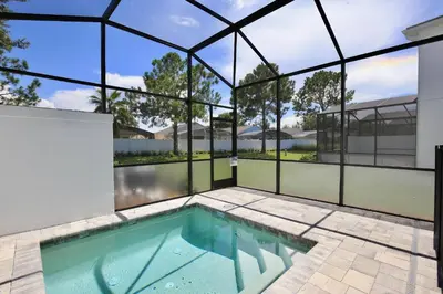 a swimming pool in the middle of a house at Great 4 bedroom townhouse in Hidden Forest, with private pool! in Orlando