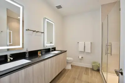 a bathroom with a sink and a toilet and a mirror at Great 4 bedroom townhouse in Hidden Forest, with private pool! in Orlando