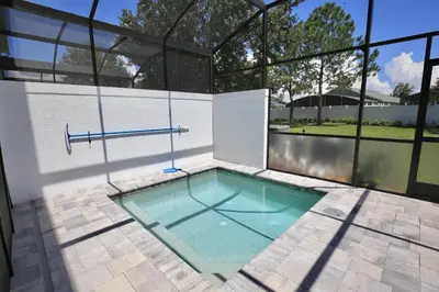 a swimming pool with a swing in a house at Great 4 bedroom townhouse in Hidden Forest, with private pool! in Orlando