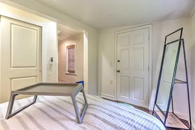 a glass table in a room with a mirror at 16 Mi to Disney Cottage with Deck in Winter Garden in Orlando