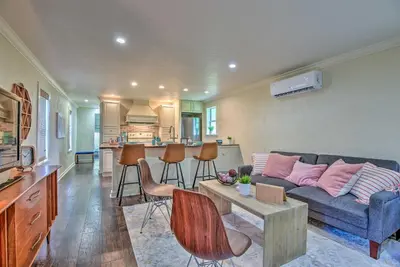 a living room with a couch and a table at 16 Mi to Disney Cottage with Deck in Winter Garden in Orlando