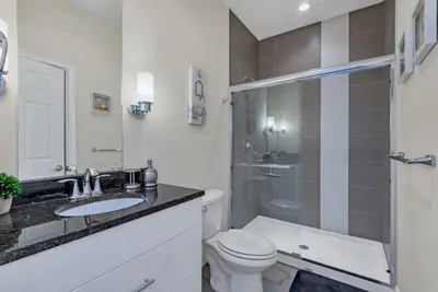 a bathroom with a toilet and a sink and a shower at Serenity 3 Bed Townhome townhouse in Orlando