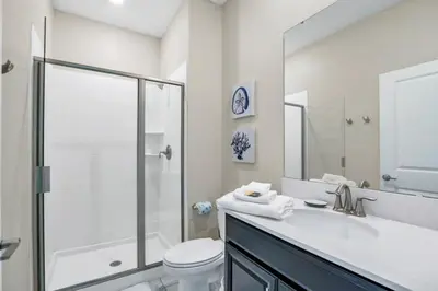 a bathroom with a sink and a toilet and a shower at Brand New Storey Lake Resort With Water Slides townhouse in Kissimmee