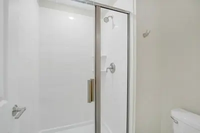 a shower with a glass door in a bathroom at Brand New Storey Lake Resort With Water Slides townhouse in Kissimmee