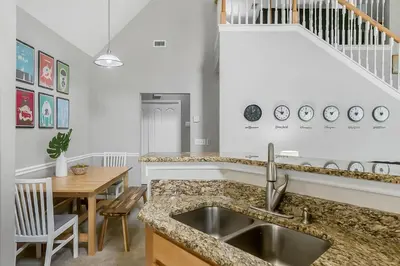 a kitchen with a sink and a dining room at Cozy Apartment Only Miles From Disney Community Pool And Jacuzzii in Kissimmee