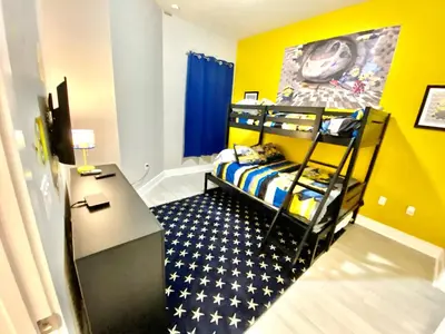 a small bedroom with a bunk bed and a desk at Magical Vacation Home 3 min from Disney in Orlando