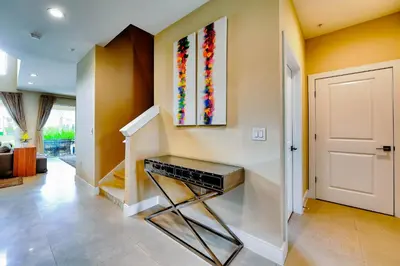 a room with a staircase with a painting on the wall at Beautiful Townhome Overlooking The Lake And The Pool in Orlando