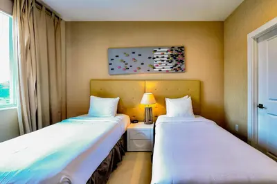 two beds sitting next to each other in a room at Beautiful Townhome Overlooking The Lake And The Pool in Orlando