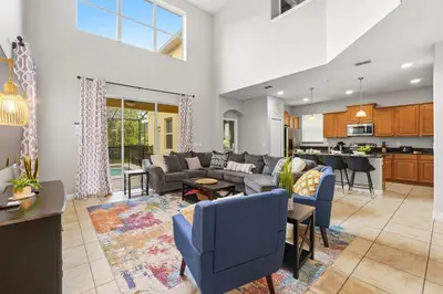 a living room with couches and a kitchen at Appealing, Large 5BD Home Close to Themed-Parks #5PP961 in Kissimmee