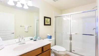 a bathroom with a shower and a sink and a toilet at Spacious 6BR Villa with Pool SPA 3 Miles to Disney in Orlando