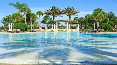 a large swimming pool with a gazebo and palm trees at Spacious 6BR Villa with Pool SPA 3 Miles to Disney in Orlando