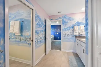 a bathroom with a mural of snow capped mountains at Luxury Villa near Disney 8 Bedroom Private Pool & Playground1 in Kissimmee