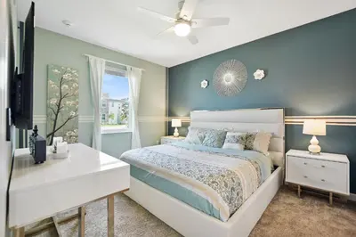 a bedroom with a bed and a dresser and a window at Luxury Villa near Disney 8 Bedroom Private Pool & Playground1 in Kissimmee