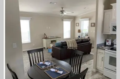 a kitchen and living room with a table and a couch at Resort Cottage near parks at Great Price! in Kissimmee