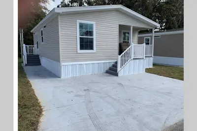 a house with a large concrete driveway at Resort Cottage near parks at Great Price! in Kissimmee