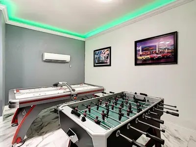 a game room with a foosball table and a video game at Luxury Family Villa Pool Hot Tub Close to Disney in Orlando