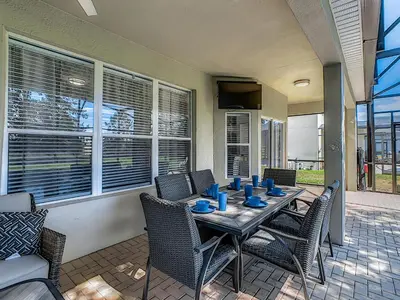 a dining room with a table and chairs at Luxury Family Villa Pool Hot Tub Close to Disney in Orlando