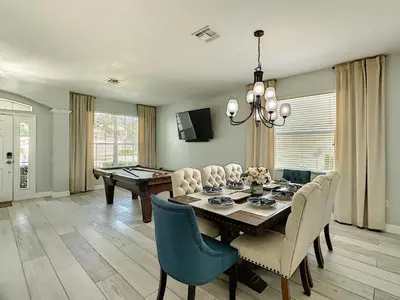 a dining room with a ping pong table and chairs at Luxury Family Villa Pool Hot Tub Close to Disney in Orlando
