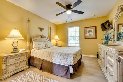 a bedroom with a bed and a ceiling fan at Spacious Kissimmee Family Home with Game Room and Pool in Kissimmee