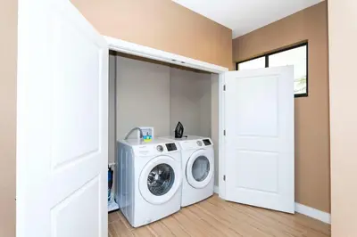 a washing machine in a laundry room with a door at Gorgeous 4Bd Close to Disney @ Magic Village 7581 in Orlando